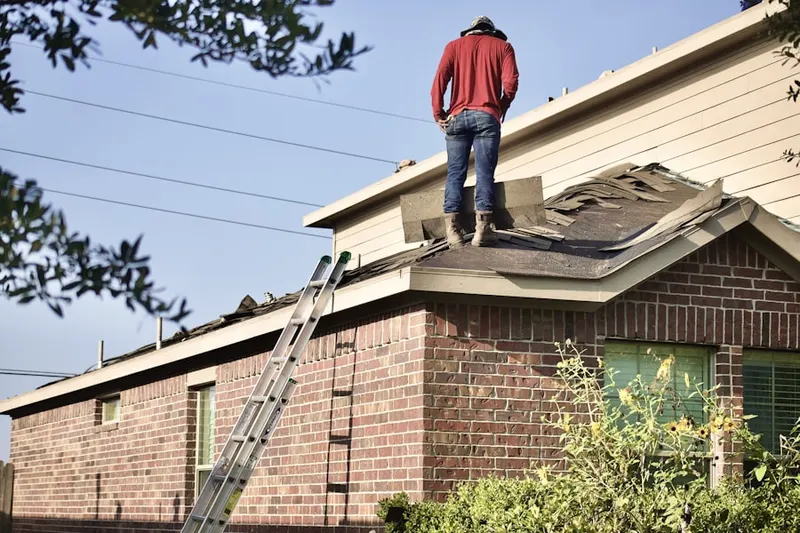 Professional roofer working on a residential roof in Town Commons
